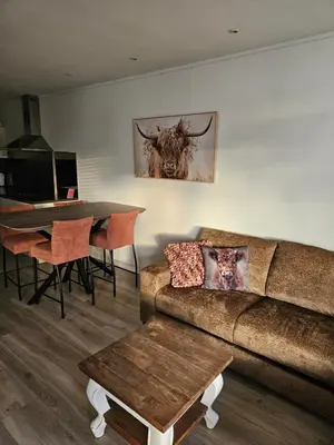 a living room with a couch and a table at Sterflat 157 in Egmond aan Zee
