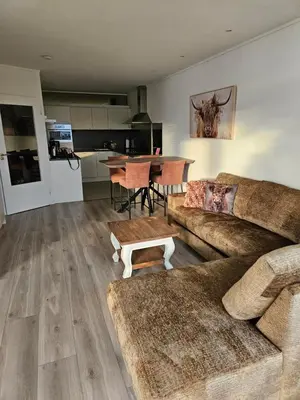 a living room with a couch and a table at Sterflat 157 in Egmond aan Zee