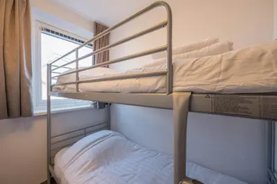 two bunk beds in a room with a window at Meerzicht 71 - Perfectly suited for 6 persons in Uitgeest