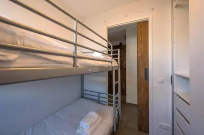 a room with two bunk beds and a hallway at Meerzicht 71 - Perfectly suited for 6 persons in Uitgeest