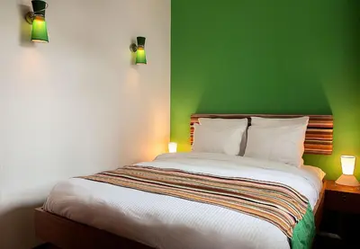 a bedroom with a green wall and a bed at Prinsenhuis in Amsterdam