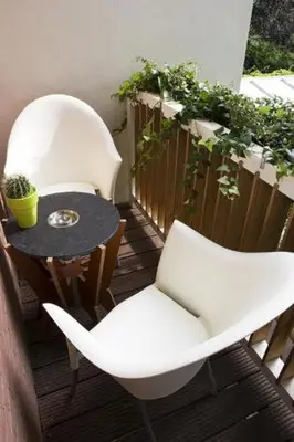 two white chairs and a table on a balcony at Prinsenhuis in Amsterdam
