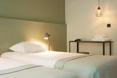 two beds sitting next to each other in a room at Buitenplaats de Bergse Bossen in Driebergen