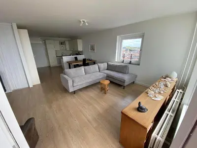 a living room with a couch and a table at Sterflat 173 in Egmond aan Zee