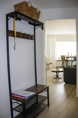 a shelf with a basket on top of it in a room at Sterflat 179 in Egmond aan Zee