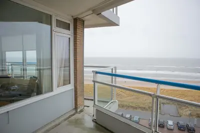 a balcony with a view of the ocean at Sterflat 185 in Egmond aan Zee