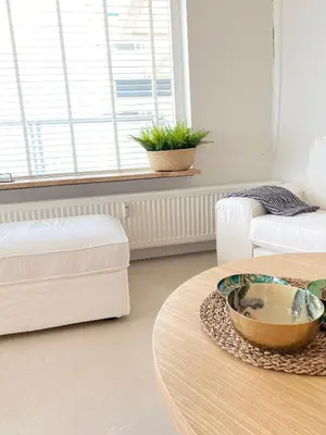 a living room with a coffee table and a couch at Sterflat 189 in Egmond aan Zee