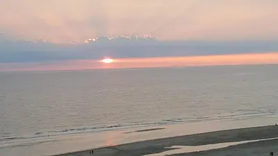 a view of the ocean with the sun setting at Sterflat 199 in Egmond aan Zee