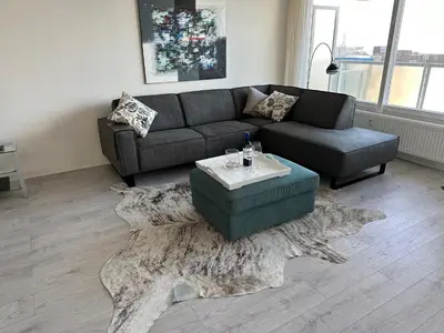 a living room with a couch and a coffee table at Sterflat 199 in Egmond aan Zee