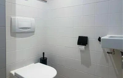 a white bathroom with a toilet and a sink at Gorgeous Apartment In Bergen Aan Zee in Bergen aan Zee
