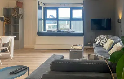 a living room with a couch and a window at Gorgeous Apartment In Bergen Aan Zee in Bergen aan Zee