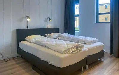a bed in a room with two pillows on it at Gorgeous Apartment In Bergen Aan Zee in Bergen aan Zee