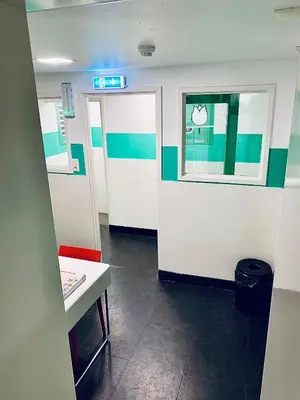 a hospital hallway with a door and a window at The White Tulip Hostel in Amsterdam