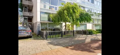 a car parked in front of a tall building at Spacious 3-Bedroom Apartment Amsterdam West - by Peter in Amsterdam