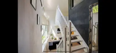 a white staircase in a house with a window at Spacious 3-Bedroom Apartment Amsterdam West - by Peter in Amsterdam