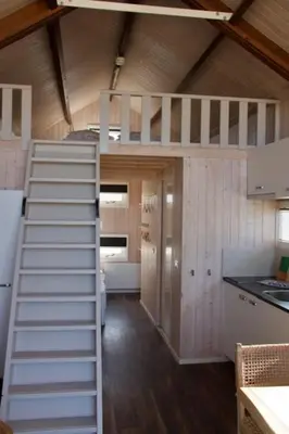 a room with a staircase in a tiny house at Sisters Beachbungalows in Katwijk aan Zee