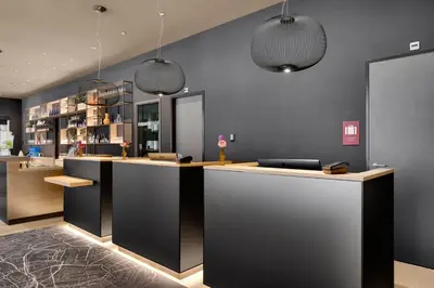 a bar with two pendant lights in a room at IntercityHotel Leiden in Leiden