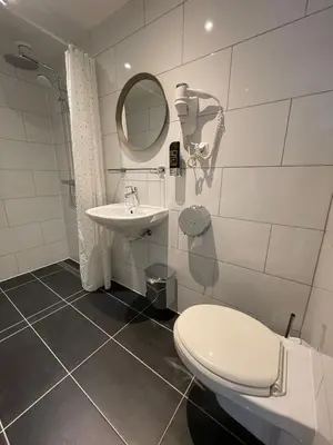 a bathroom with a toilet and a sink at Hotel Damrak Inn in Amsterdam