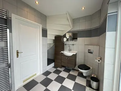 a bathroom with a toilet and a sink at Palm Beach House in Zandvoort