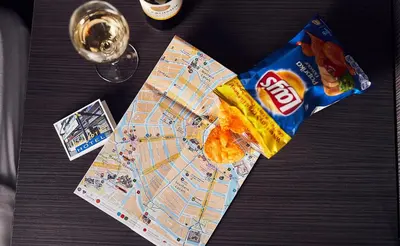 a table with a map and a bag of chips at Belfort Hotel in Amsterdam