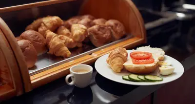 a plate of food on a table with a plate of pastries at Belfort Hotel in Amsterdam