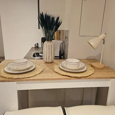 a kitchen counter with plates and a vase on it at Il Mulino House A in Lisse