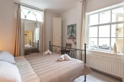 a bedroom with a bed with two stuffed animals on it at Historical Tiny Home (+Private Sauna) in Zandvoort