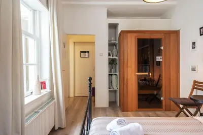 a bedroom with a bed and a window and a door at Historical Tiny Home (+Private Sauna) in Zandvoort
