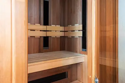 a wooden cabinet with a fireplace in a room at Historical Tiny Home (+Private Sauna) in Zandvoort