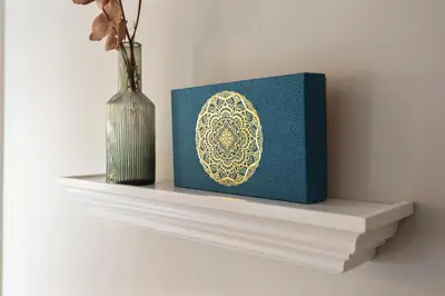 a book sitting on a shelf next to a vase at Historical Tiny Home (+Private Sauna) in Zandvoort