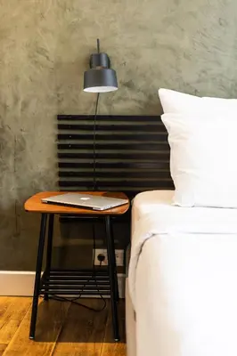 a table sitting next to a bed with a lamp at Weber Hotel 397 in Amsterdam
