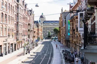 a city street with buildings and people walking down the street at Weber Hotel 397 in Amsterdam