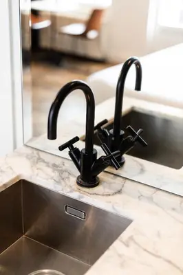 a kitchen sink with a black kitchen faucet at Weber Hotel 397 in Amsterdam