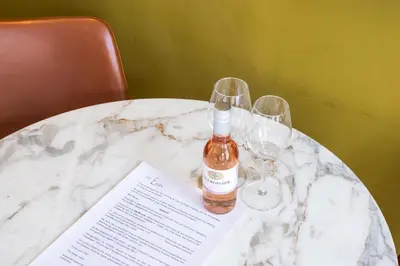 a bottle of wine sitting on a table with two wine glasses at Weber Hotel 397 in Amsterdam