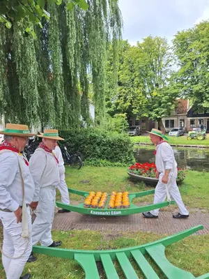 a group of men in white uniforms with a table of carrots at Aan de Dijk in Edam