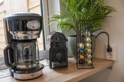 a counter with a coffee maker and a blender at Kahakai Beach House - Unique Outdoor Kitchen - next to local lake and 15 min. the from beach in Noordwijkerhout