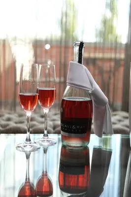 two wine glasses and a bottle on a table at Hotel Mijdrecht Marickenland in Mijdrecht