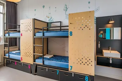 a room with bunk beds with a sink at Stayokay Hostel Amsterdam Oost in Amsterdam