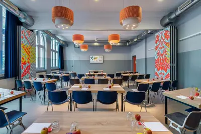 a dining room with tables and chairs at Stayokay Hostel Amsterdam Oost in Amsterdam