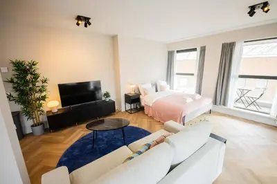 a living room with a couch and a bed at Alphabet Apartments - Kerkstraat 71 in Hilversum