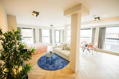 a living room with a couch and a table at Alphabet Apartments - Kerkstraat 71 in Hilversum