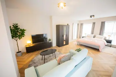 a living room with a couch and a bed at Alphabet Apartments - Kerkstraat 71 in Hilversum