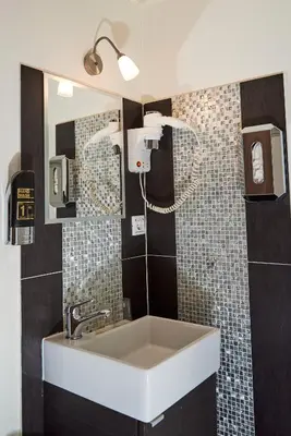 a bathroom with a sink and a mirror at ITC Hotel in Amsterdam