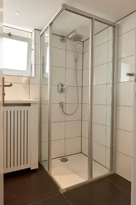 a shower with a glass enclosure in a bathroom at ITC Hotel in Amsterdam