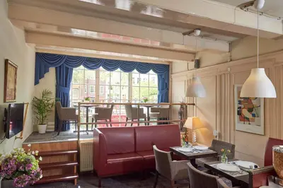 a living room with a couch and a table at ITC Hotel in Amsterdam