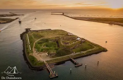 an island in the water next to the ocean at DD 58 - Camping de Duindoorn - AIRCO in IJmuiden