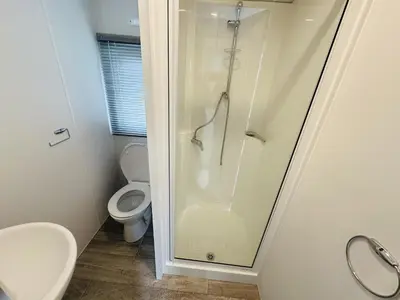 a bathroom with a shower and a toilet at DD 58 - Camping de Duindoorn - AIRCO in IJmuiden