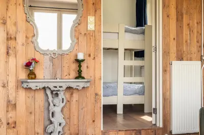 a mirror on the wall of a room with a bunk bed at Holiday home Landelijk Amsterdam in Amsterdam
