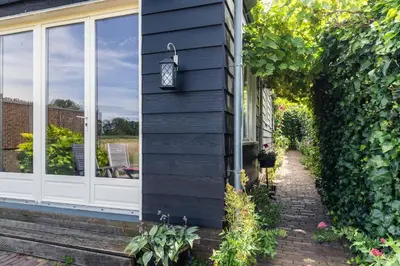 a house with a black wall and a window at Holiday home Landelijk Amsterdam in Amsterdam