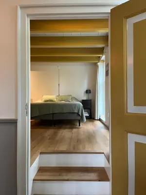 a bedroom with a bed in a room at Kleinhoef - charmante, luxe kamers in een boerderij uit 1875 in Nigtevecht